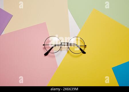 Eyeglasses with metal round rim is on abstract background. Stock Photo