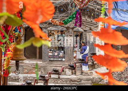 Woman stops at a shop in Kathmandu, brightly framed Nepal Stock Photo