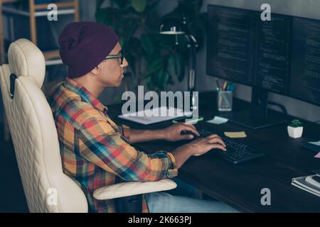 Profile portrait of smart web designer guy sitting chair keyboard writing typing workplace indoors Stock Photo