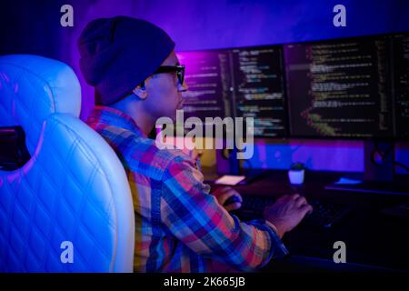 Profile photo of professional cybersecurity agent keyboard typing operating dark office room inside Stock Photo