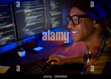 Profile portrait of cheerful intelligent guy operation server debugging late evening workstation indoors Stock Photo