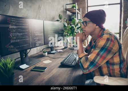 Profile photo of minded creative person sitting chair look monitor brainstorming database optimization workstation indoors Stock Photo