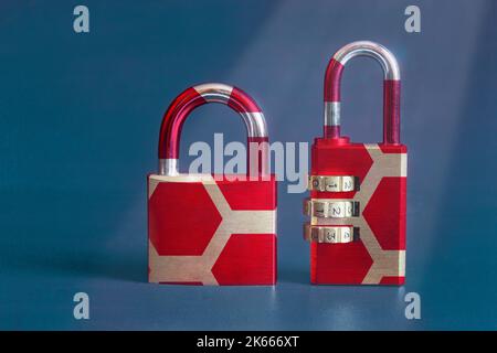 A close-up of a modern image of two vintage padlocks with a colorful original design on a textured painted studio background with copy space. Security Stock Photo