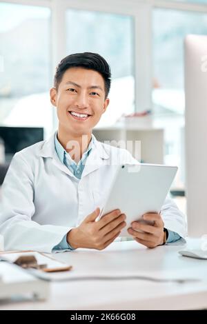 The world of science is a large one to explore. Portrait of a young scientist using a digital tablet in a lab. Stock Photo