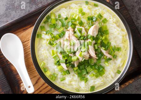 Korean chicken soup with rice and green onions close-up in a bowl on the table. Horizontal top view from above Stock Photo