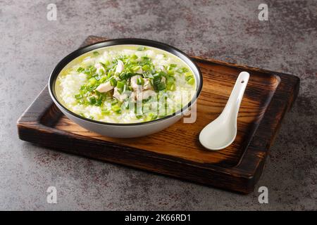 Spicy hot Korean chicken soup with rice and green onions close-up in a bowl on the table. Horizontal Stock Photo