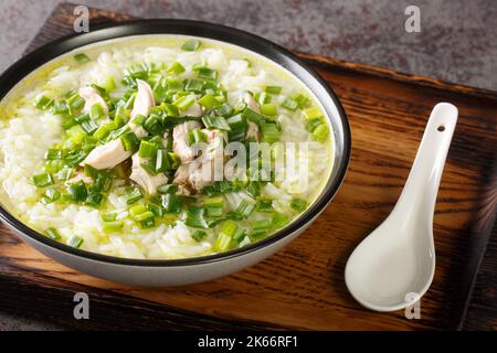 Korean chicken soup with rice and green onions close-up in a bowl on the table. Horizontal Stock Photo