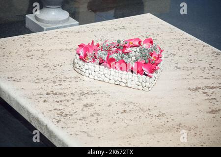 Heart on the headstone . Heart shaped bouquet at the tomb Stock Photo