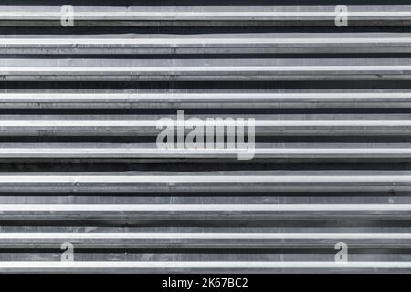 Abstract background photo texture of corrugated metal wall, front view Stock Photo