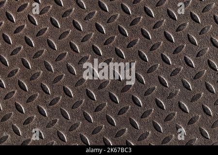 Abstract background photo texture of a grungy metal plate with diamond plate pattern. Industrial flooring, top view Stock Photo