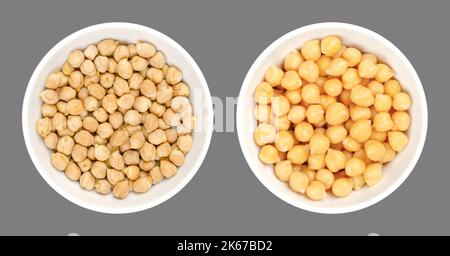 Chickpeas, dried and boiled, in white bowls, over gray. Raw and cooked chick peas, high in protein seeds of Cicer arietinum, a legume. Stock Photo