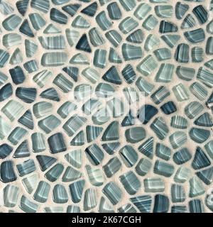 A tile wall in a bathroom in shades of blue that looks like sea glass which can be used as a background. Stock Photo