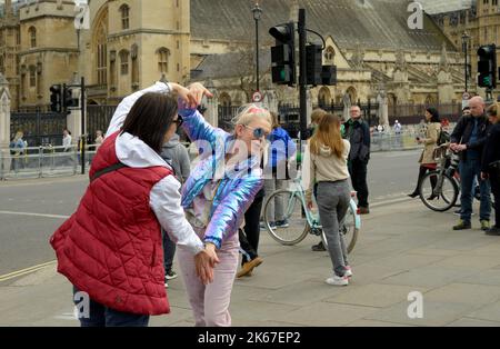 Two young women, doing a selfie, by Big Ben Stock Photo