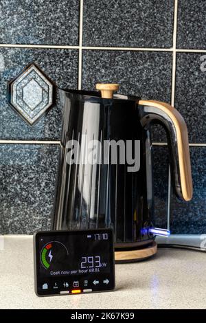 A smart meter in front of a kettle in a kitchen. Stock Photo