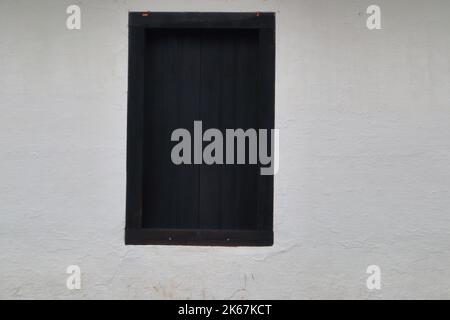 Vintage wood black window on white cement wall Stock Photo