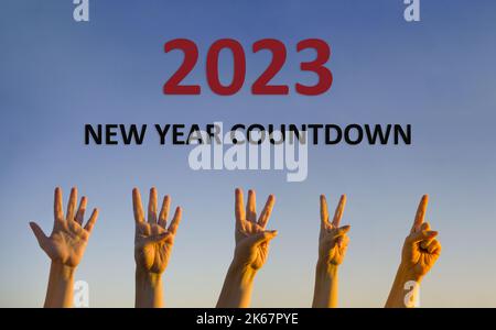 Happy New Year 2023 transition countdown. Hands counting down. High resolution photo image for large display, print, website banner, social media post. Stock Photo