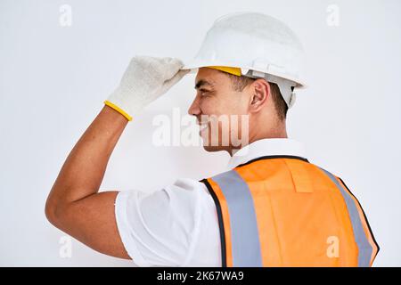 Portrait of an Asian construction worker tipping his hat facing left Stock Photo