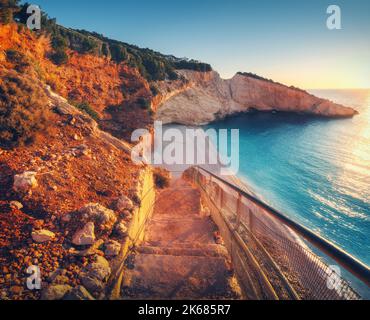 Beautiful stairs on sandy beach at sunset. Porto Katsiki, Greece Stock Photo