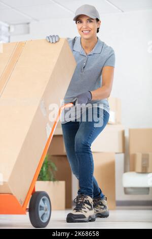 professional female mover doing home relocation Stock Photo