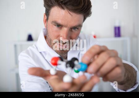 handsome scientist making research over dna molecule structure Stock Photo