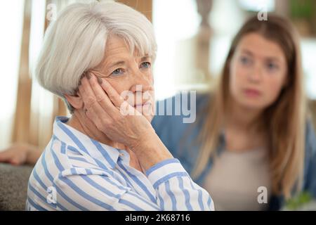 daughter comforting upset older woman having problems Stock Photo