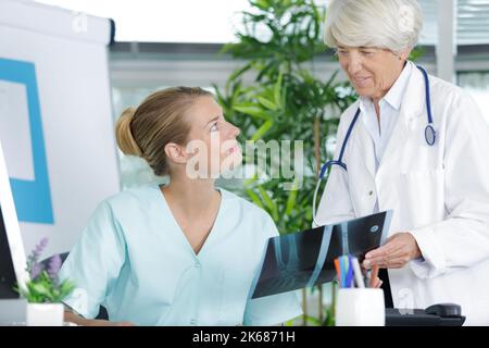 male nurse talking to senior doctor Stock Photo