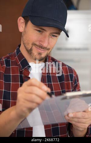 young man doing stocktaking of product Stock Photo