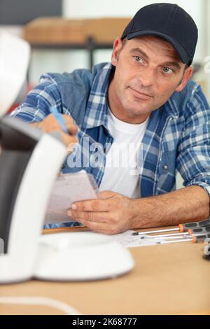 professional young worker fixing coffee machine Stock Photo