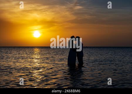 Young loving couple at sunset in the Caribbean. Stock Photo