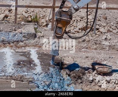 Excavator with demolition hammer in a construction site Stock Photo