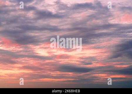lilac blue sunset pink sky fluffy clouds on gold sunset summer tropical nature background landscape Stock Photo