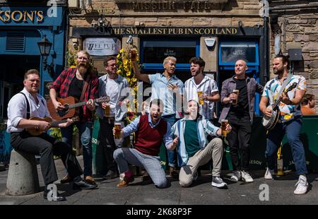 Choir of Man group singing, playing music and drinking beer at The Smallest pub in Scotland, Grassmarket, Edinburgh, Scotland, UK Stock Photo