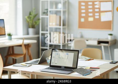 Background image of open laptop on workplace desk in creative office interior, copy space Stock Photo