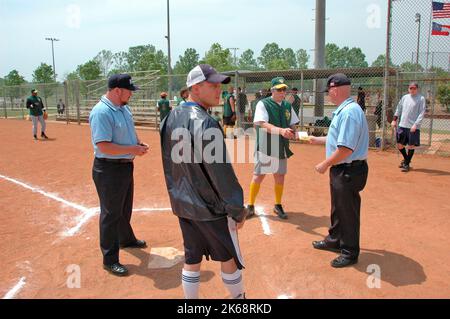 softball umpires for ASA in the US during games and in preganme checking bats and lineups and rules and such Stock Photo