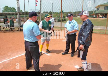 softball umpires for ASA in the US during games and in preganme checking bats and lineups and rules and such Stock Photo