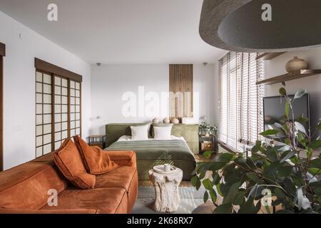 Modern Japandi appartment interior design in earth tones, natural textures with wooden solid oak furniture and sliding Japanese wood doors. Japandi co Stock Photo