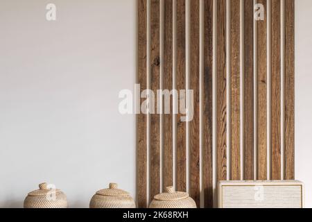 Modern Japandi appartment interior design in earth tones, natural textures. Solid oak wood wall decoration. Japandi concept Stock Photo