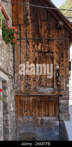 wooden door to a side barn on a traditional Spanish village dwelling, Pyrenees mountains, Spain Stock Photo