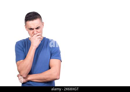 Man with his hand on his face thinking seriously Stock Photo