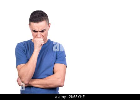 Man with his hand on his face while thinking serious Stock Photo