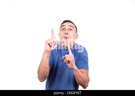 Portrait of a surprised man pointing up with his fingers Stock Photo