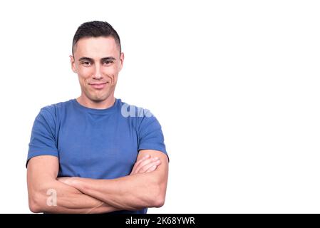 Smiling man standing with arms crossed and relaxed expression Stock Photo