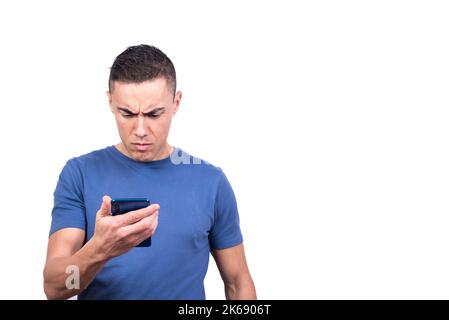 Man looking at the mobile phone with a serious expression Stock Photo