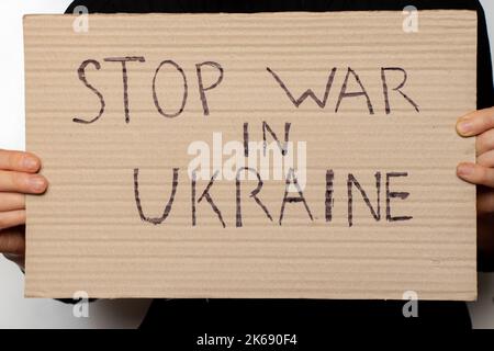 Stop the war in Ukraine written on a sign that a woman holds in her hands from her house in the Dnieper, protest action, martial law in Ukraine Stock Photo
