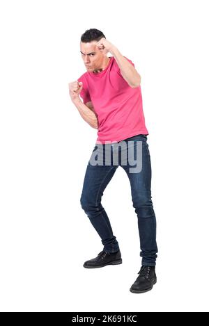 Confident young guy fighting in white studio Stock Photo
