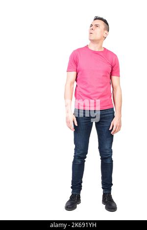 Bewildered man looking away thoughtfully against white background Stock Photo