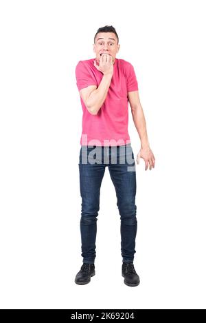 Anxious man biting nails in white studio Stock Photo
