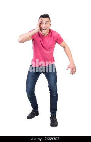 Astonished man touching face in studio. White background Stock Photo