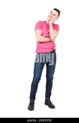 Dreamy man touching cheek in studio. White background Stock Photo