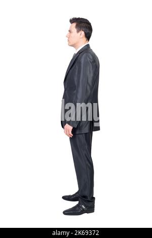 Serious male manager in suit standing in white studio Stock Photo